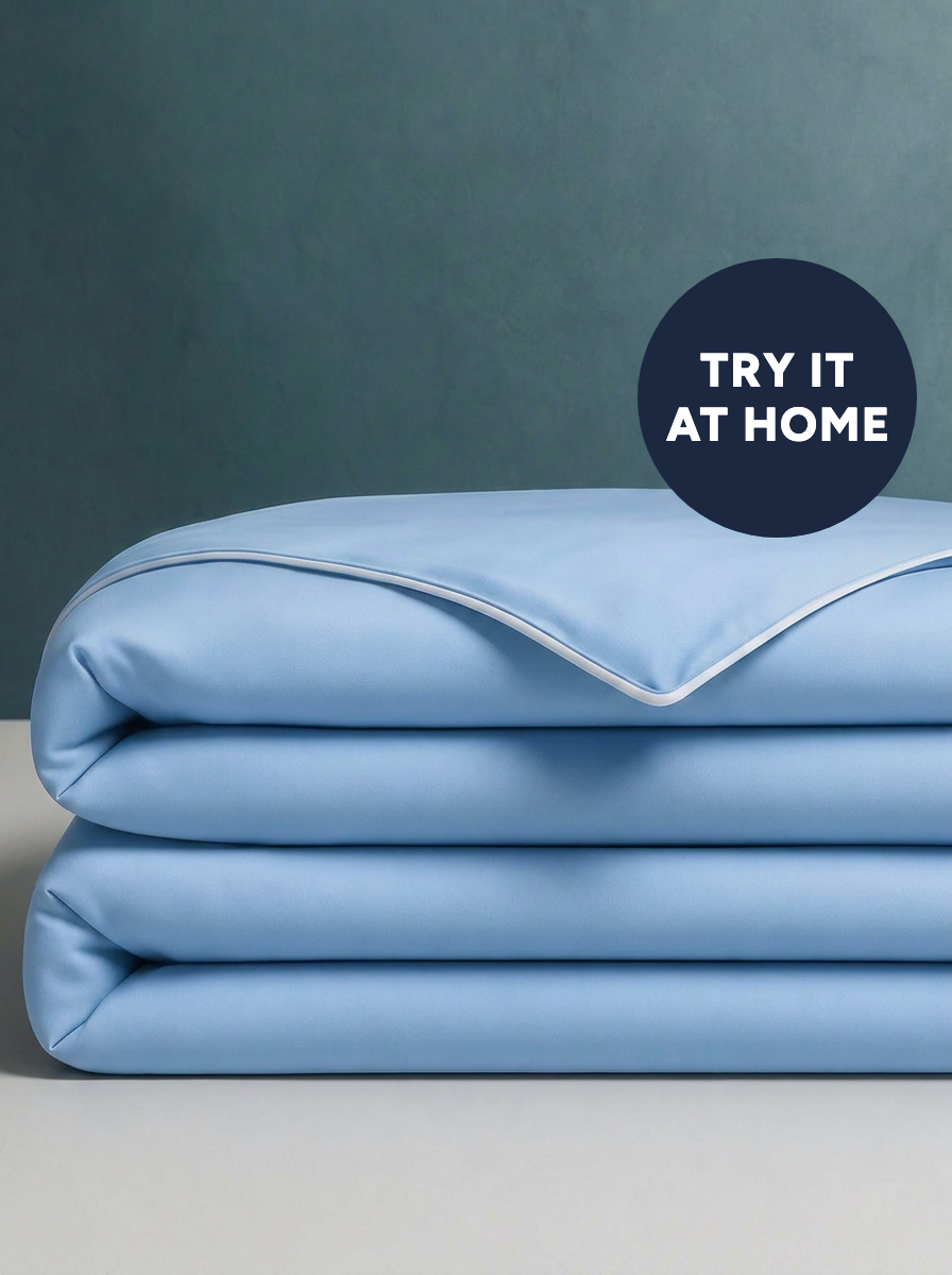 The Cooling Comforter in Frost Blue, folded · Try it at home