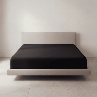The Fitted Sheet in Midnight Black on a mattress