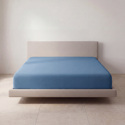 The Fitted Sheet in Coastal Blue on a mattress